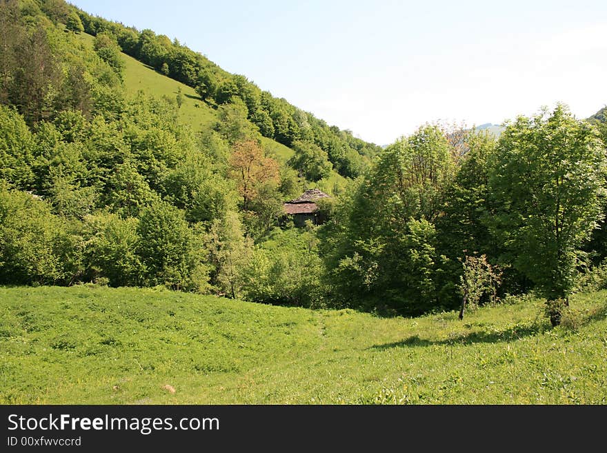 An old house with stone roof in mountain. An old house with stone roof in mountain