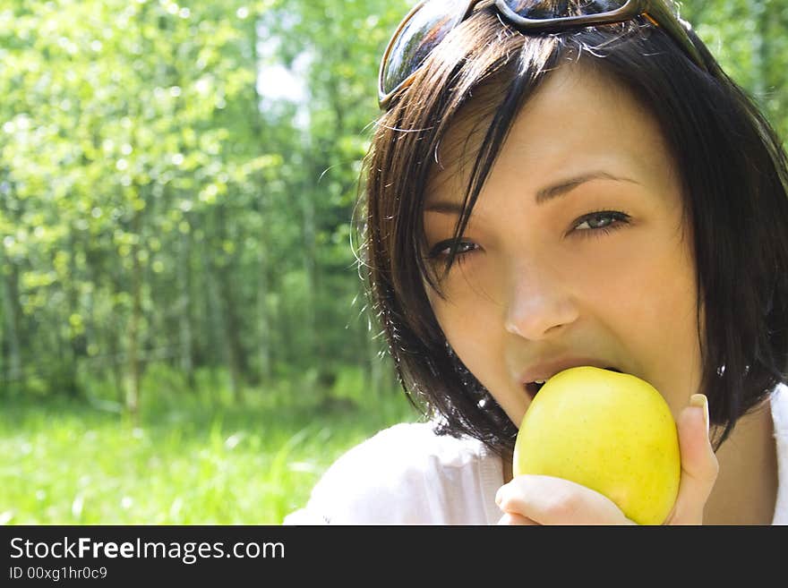 Young Happy Woman Eating Apple