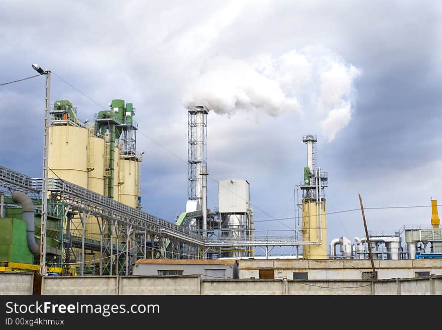 Smoke from a pipe at the plant on a background threatening sky. Smoke from a pipe at the plant on a background threatening sky