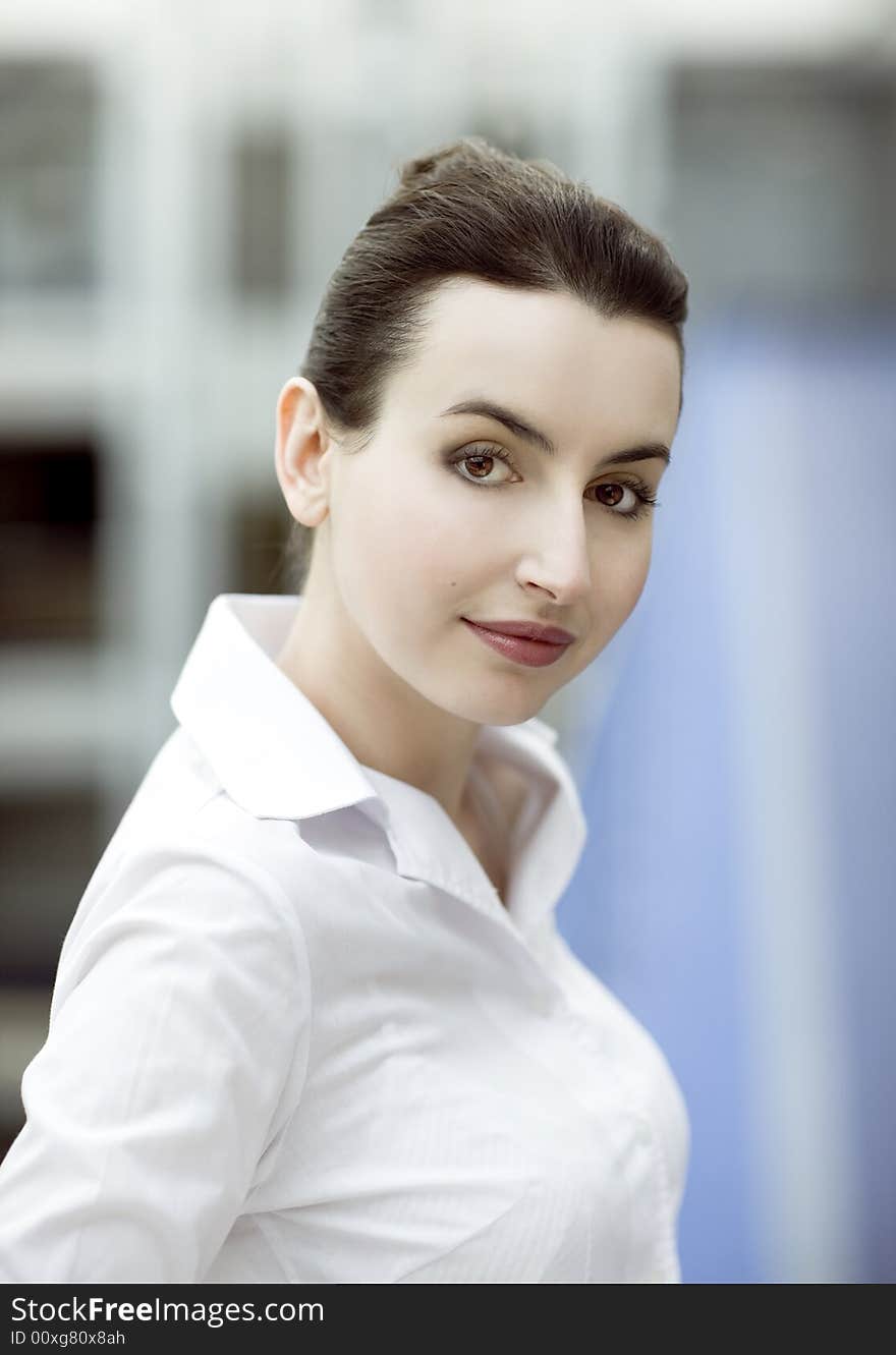 Portrait of young woman in modern office building environment. Portrait of young woman in modern office building environment