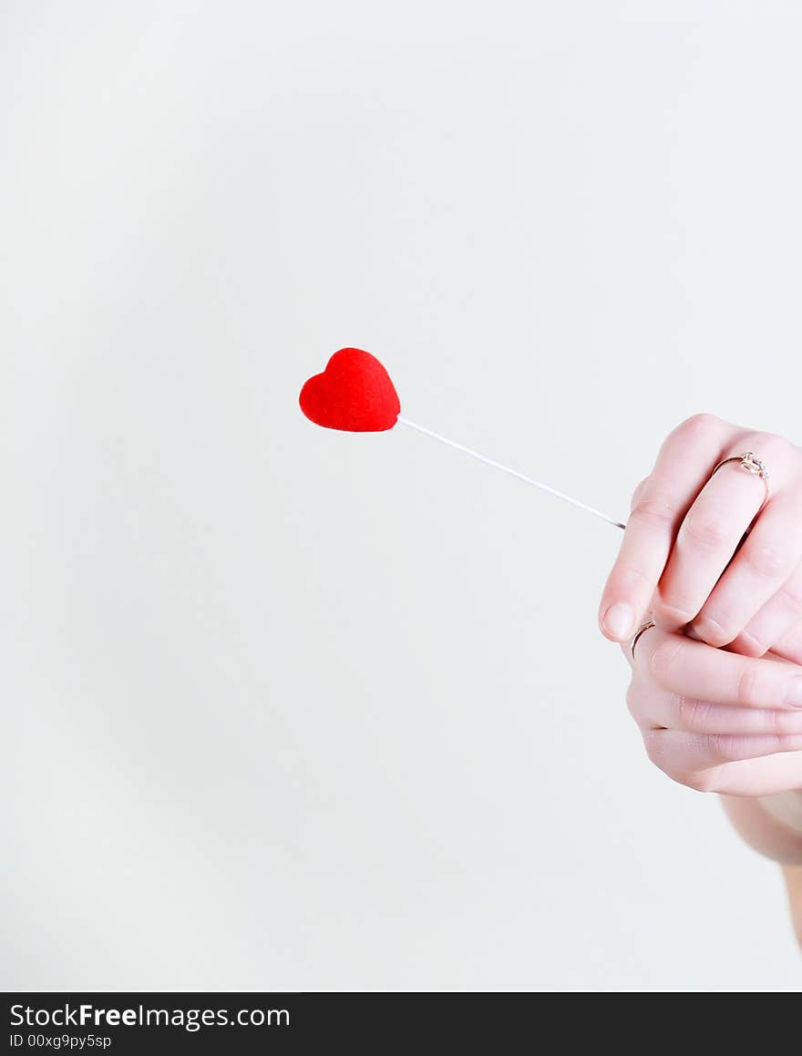 Red lovely heart in woman hands at white background. Red lovely heart in woman hands at white background