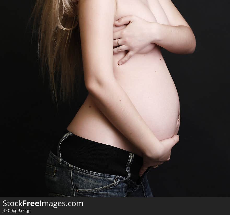 Pregnant young beauty woman at black background. Pregnant young beauty woman at black background