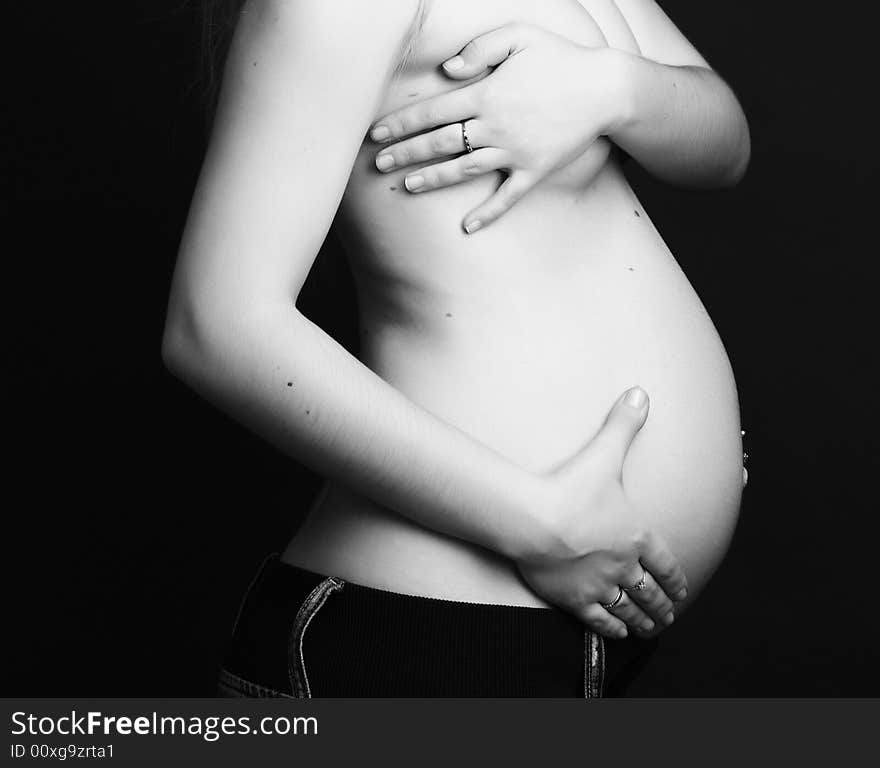 Pregnant young beauty woman at black background. Pregnant young beauty woman at black background