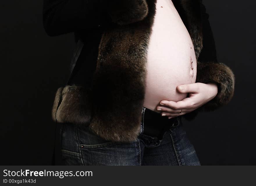 Pregnant young beauty woman at black background. Pregnant young beauty woman at black background