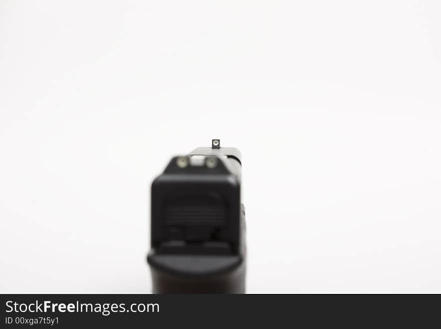 Looking down the front sight of handgun, with shallow DOF. Looking down the front sight of handgun, with shallow DOF