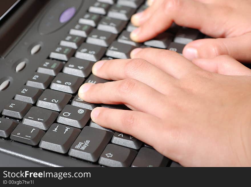 Hands of a kid on a laptop keyboard. Hands of a kid on a laptop keyboard