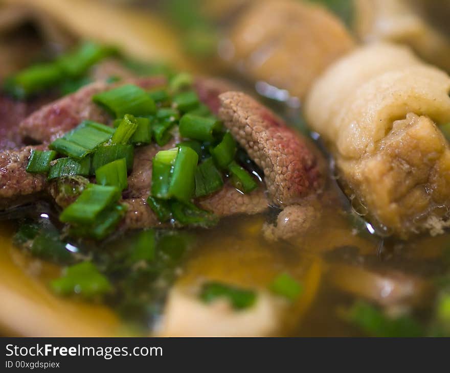 Asian dish of a tea flavored herbal clear  soup of  pork ribs, liver and stomach, served hot and sprinkled with chopped spring onions. Asian dish of a tea flavored herbal clear  soup of  pork ribs, liver and stomach, served hot and sprinkled with chopped spring onions.