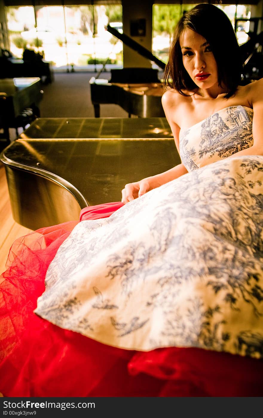 Young female model in a piano store.