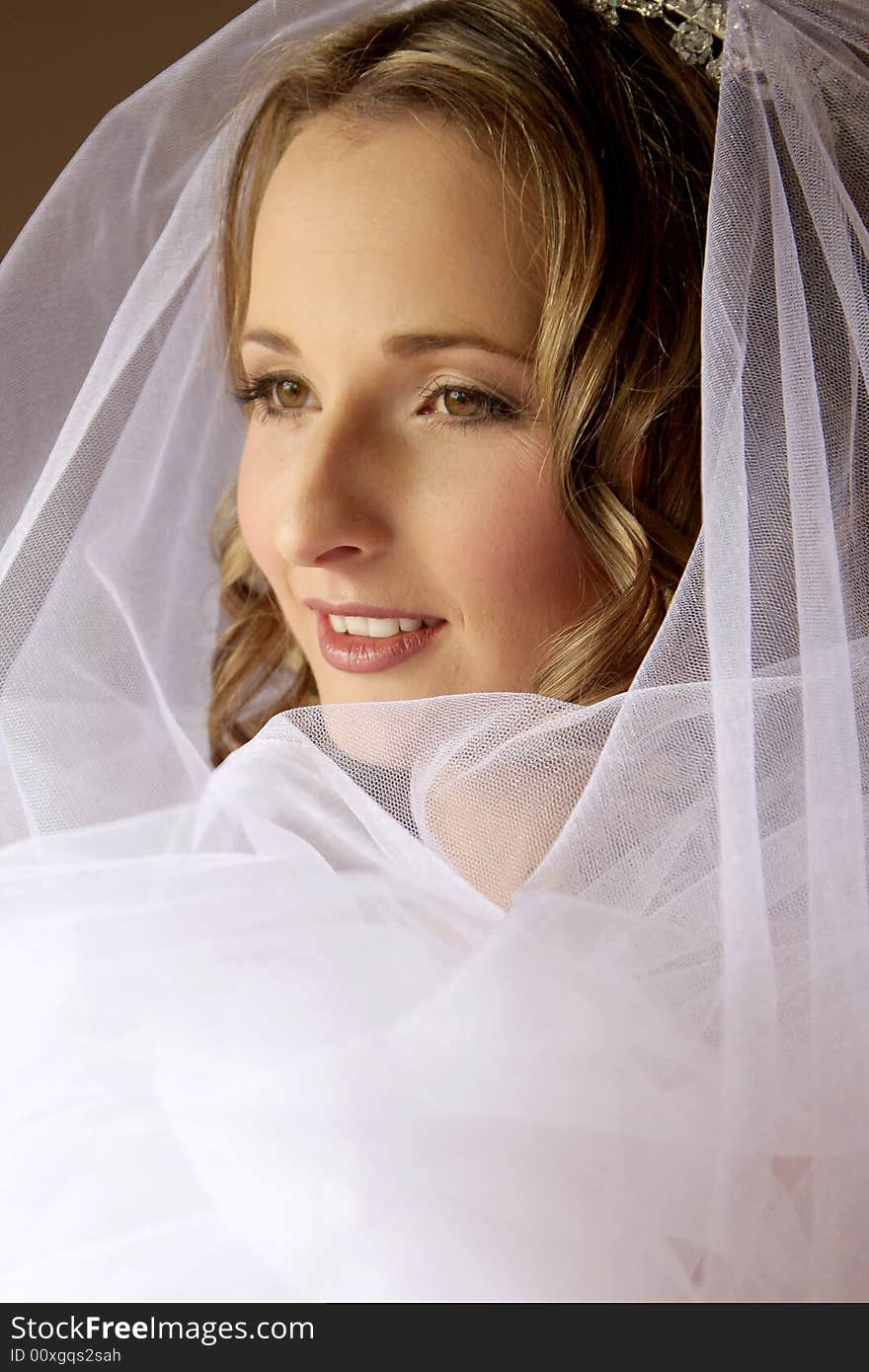 A bride sitting infront of a window. A bride sitting infront of a window