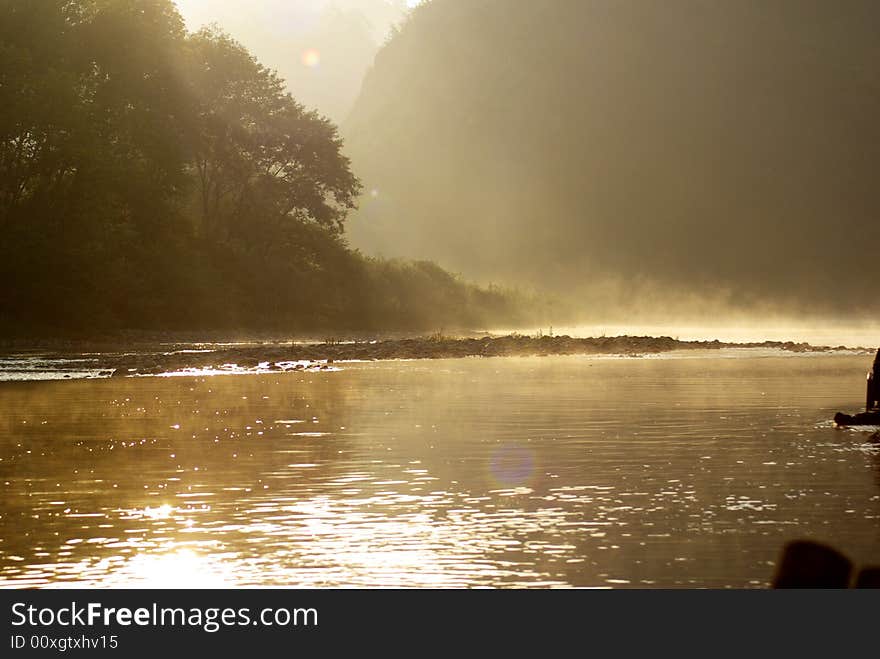 Cloud of minute drop of water vapour hanging above the river. Cloud of minute drop of water vapour hanging above the river.