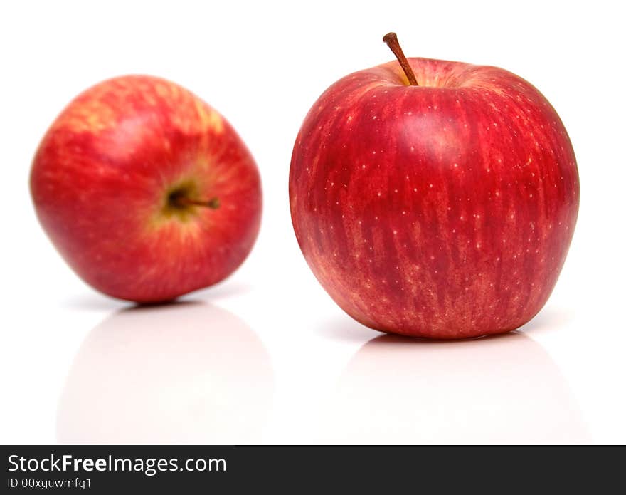 The red apple on white. Isolation, shallow DOF. The red apple on white. Isolation, shallow DOF.