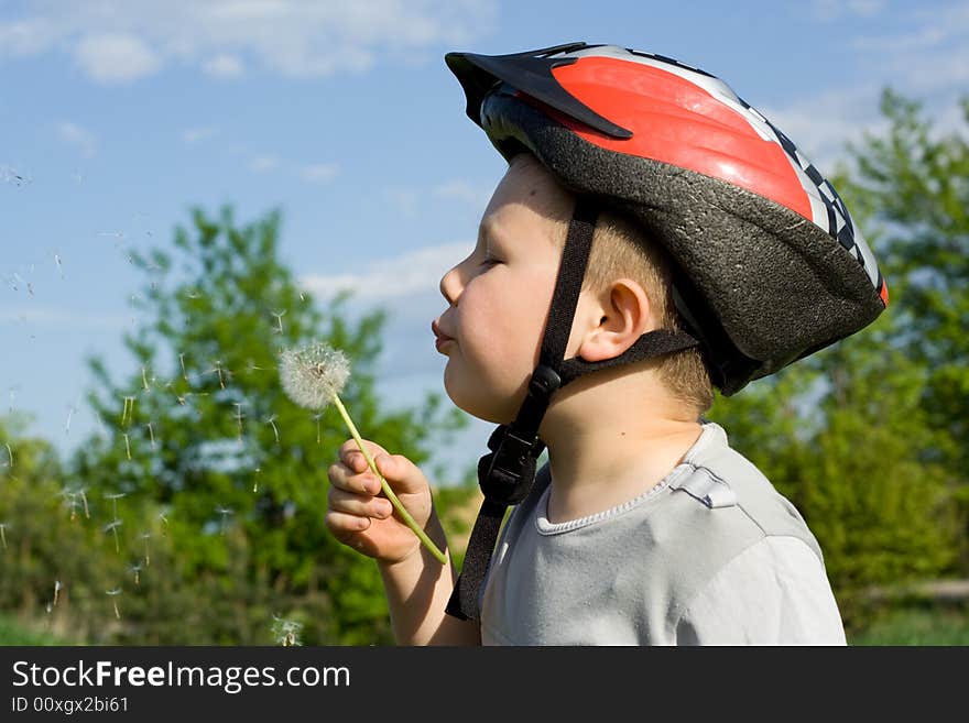 Boy Blowing Dandelion