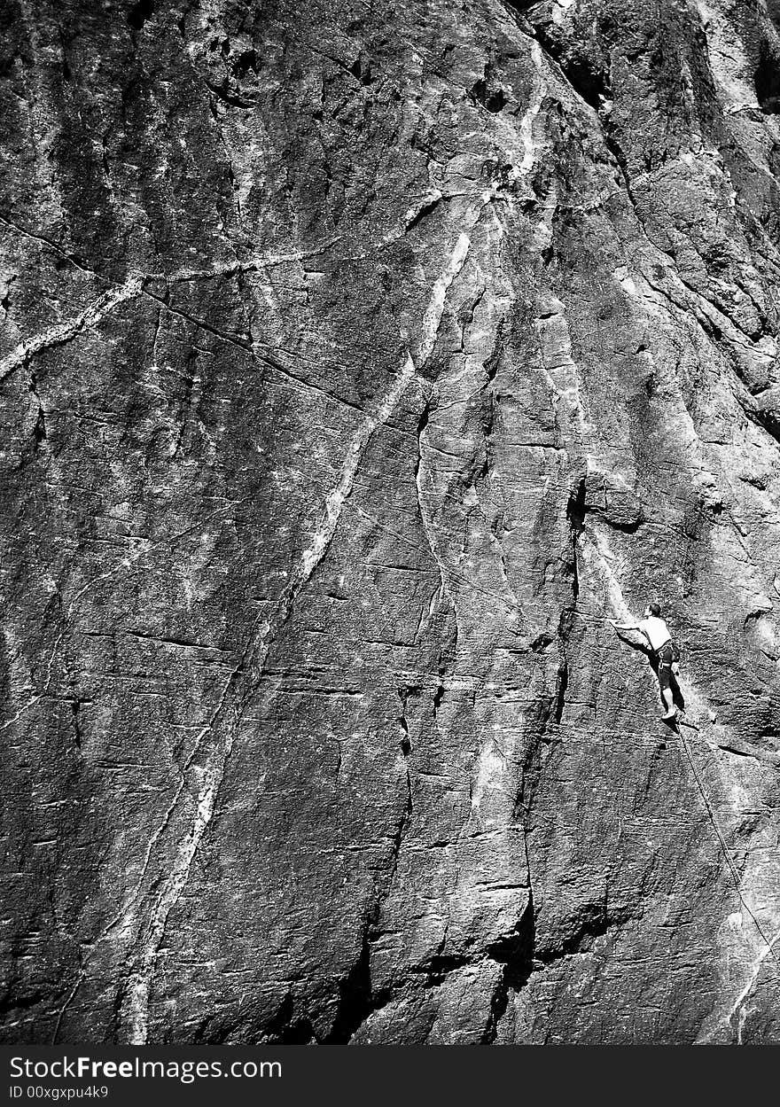 A man climbing a mountain, black and white. A man climbing a mountain, black and white.