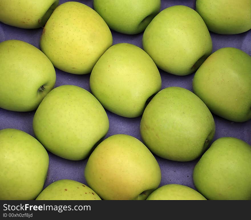 Green apples on a blue background