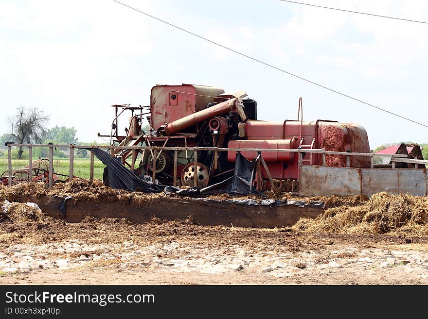 Village scene - very old harvest machine