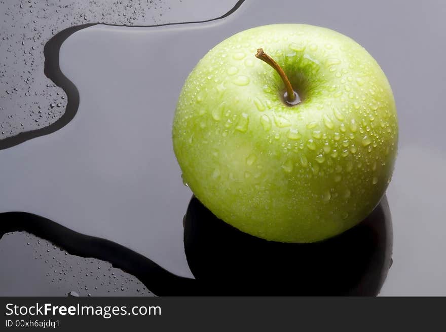 Macro to green apple on water