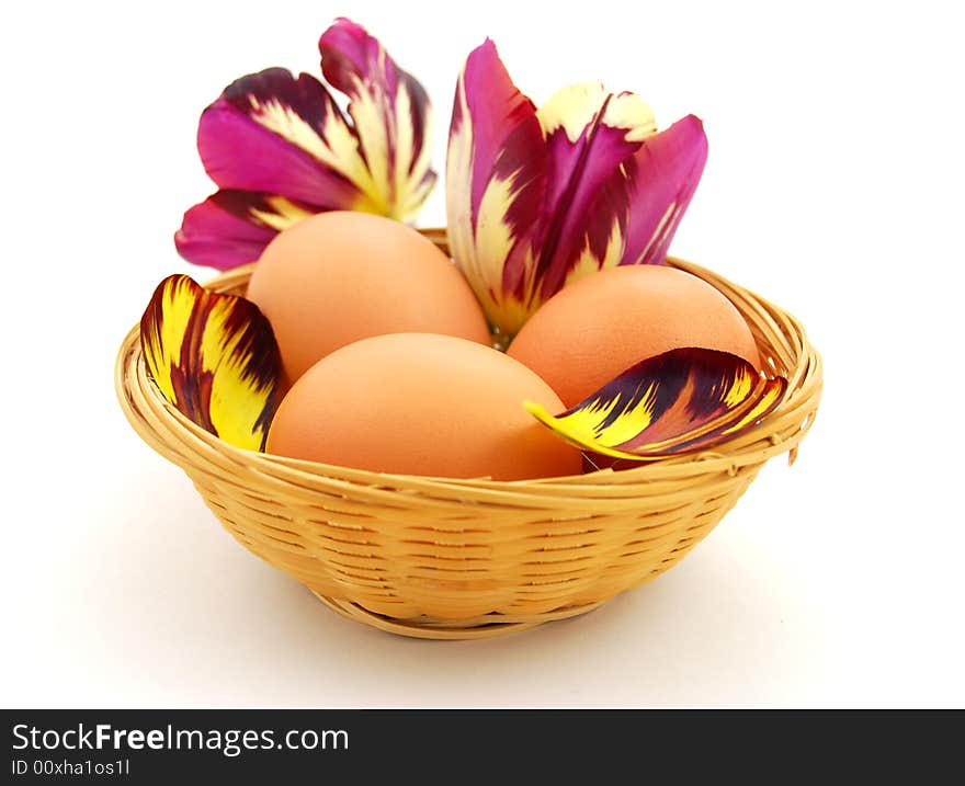 Easter eggs in basket with tulips