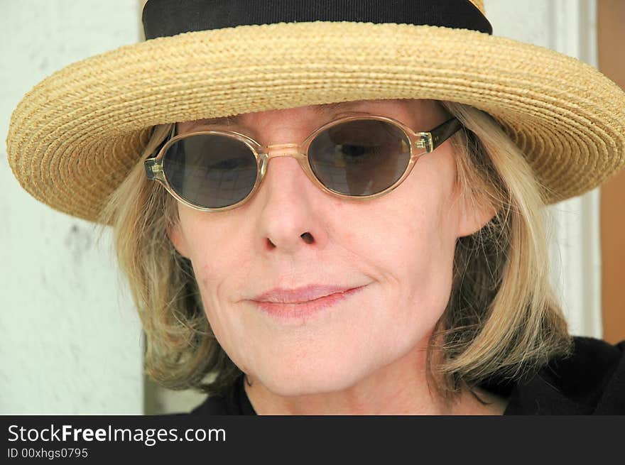 Woman from the south wearing sunglasses and a straw hat. Woman from the south wearing sunglasses and a straw hat.