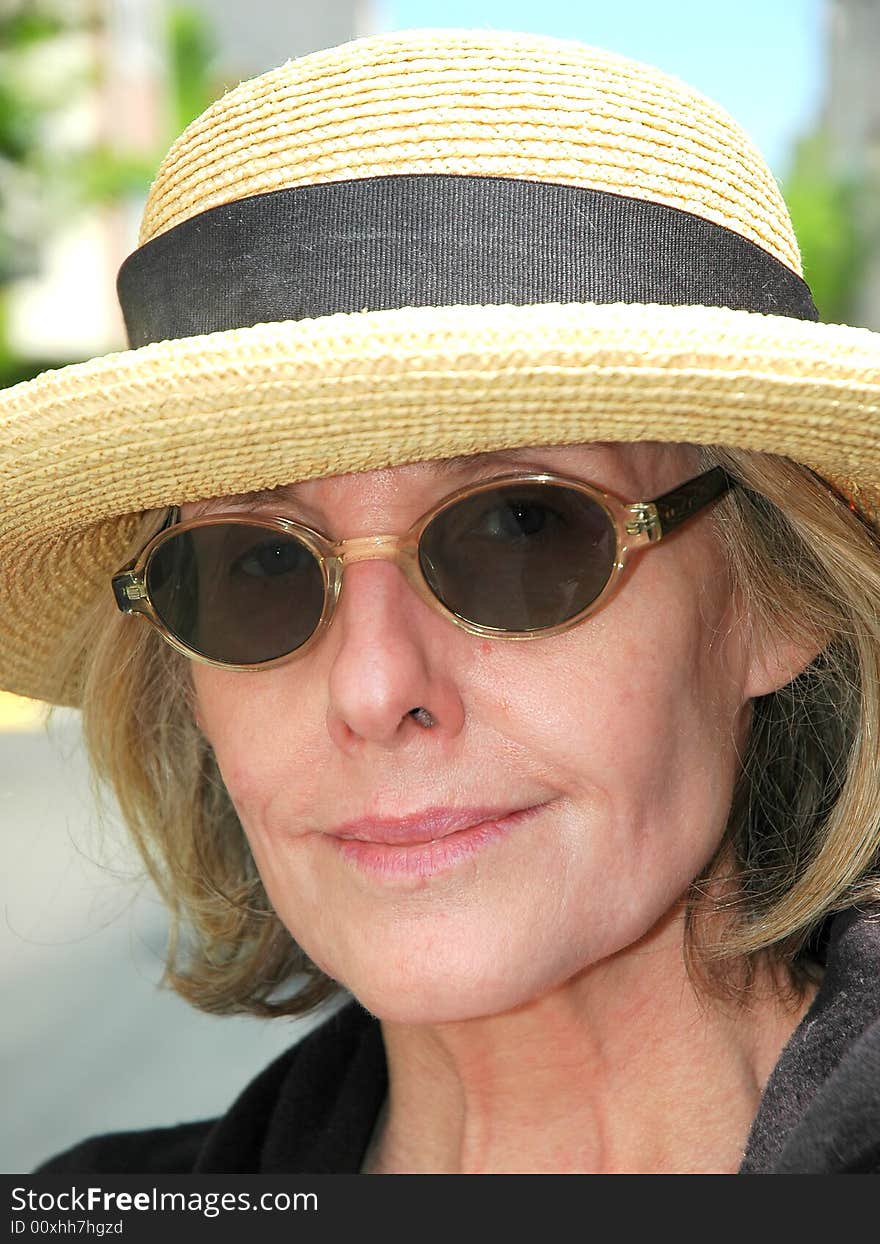 Woman from the south wearing sunglasses and a straw hat. Woman from the south wearing sunglasses and a straw hat.