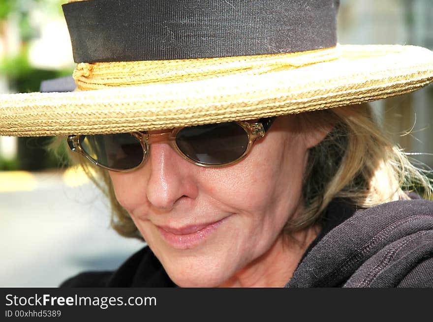 Woman from the south wearing sunglasses and a straw hat. Woman from the south wearing sunglasses and a straw hat.