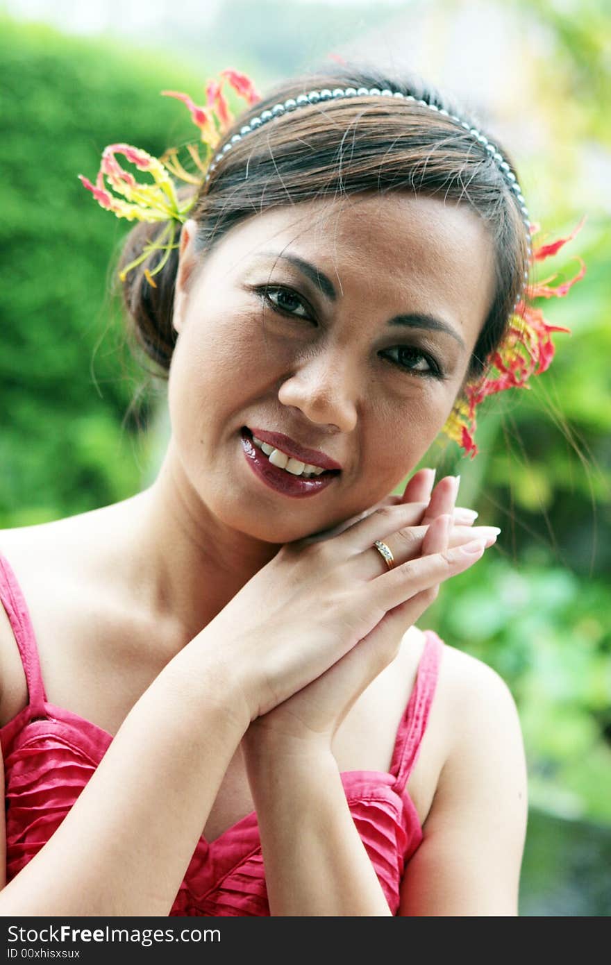 Asian matron of honor during a wedding ceremony.