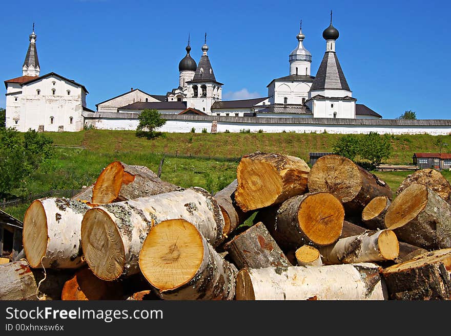 On a photo fire wood on a background of an ancient monastery