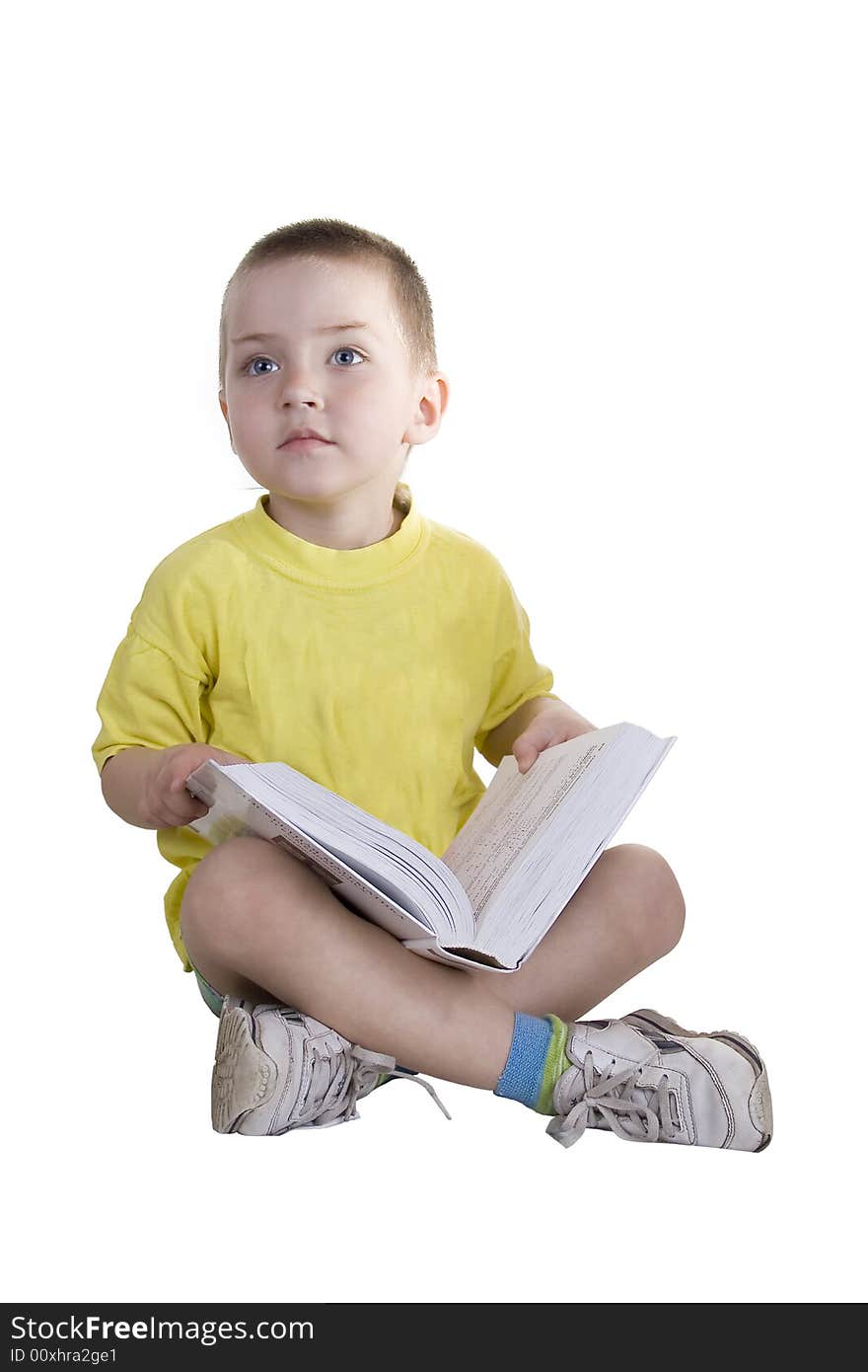 The boy reads the book on a white background. The boy reads the book on a white background