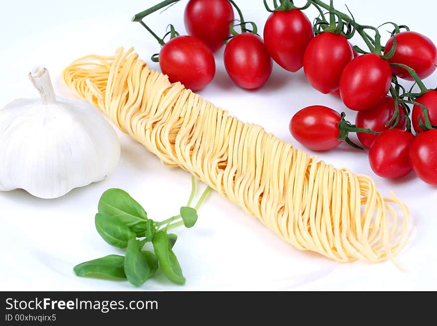 Pasta small tomatoes garlic basil isolated. Pasta small tomatoes garlic basil isolated