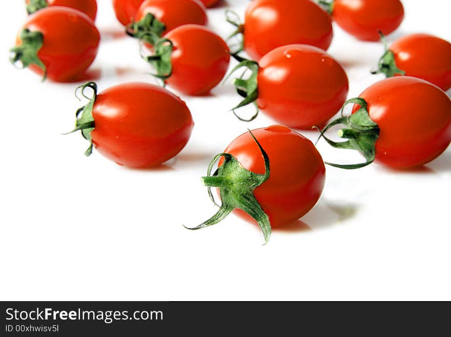 Red cherry tomatoes on a  light background