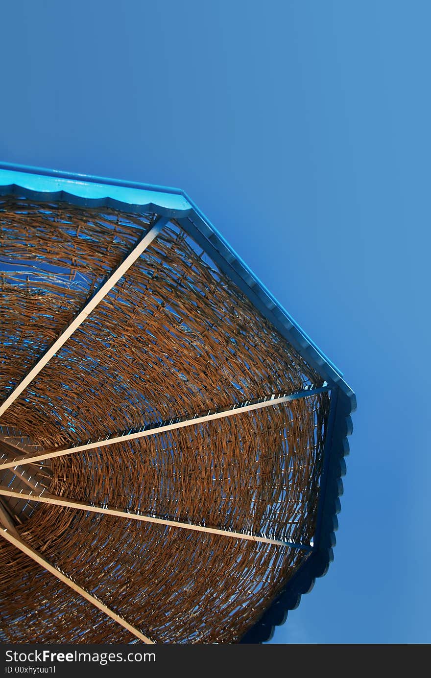 A beach umbrella against the sky