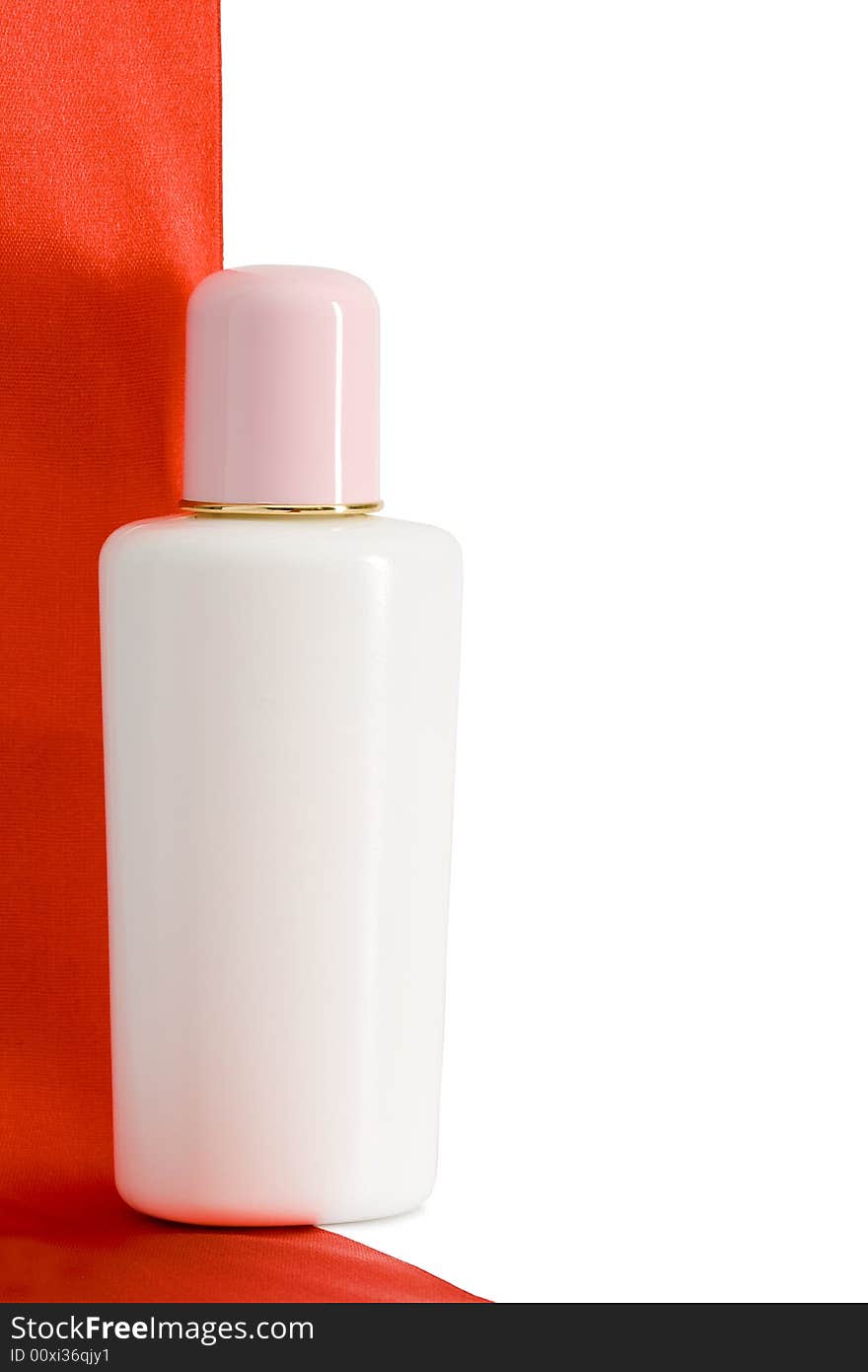 One standing bottle with red satin tape and white background