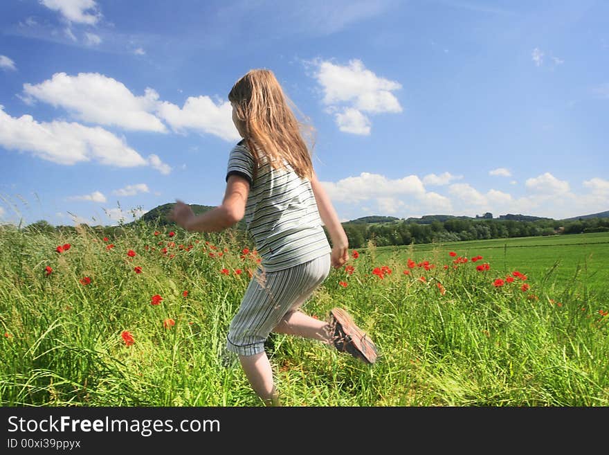 Happy child run on the field with red poppies. Happy child run on the field with red poppies