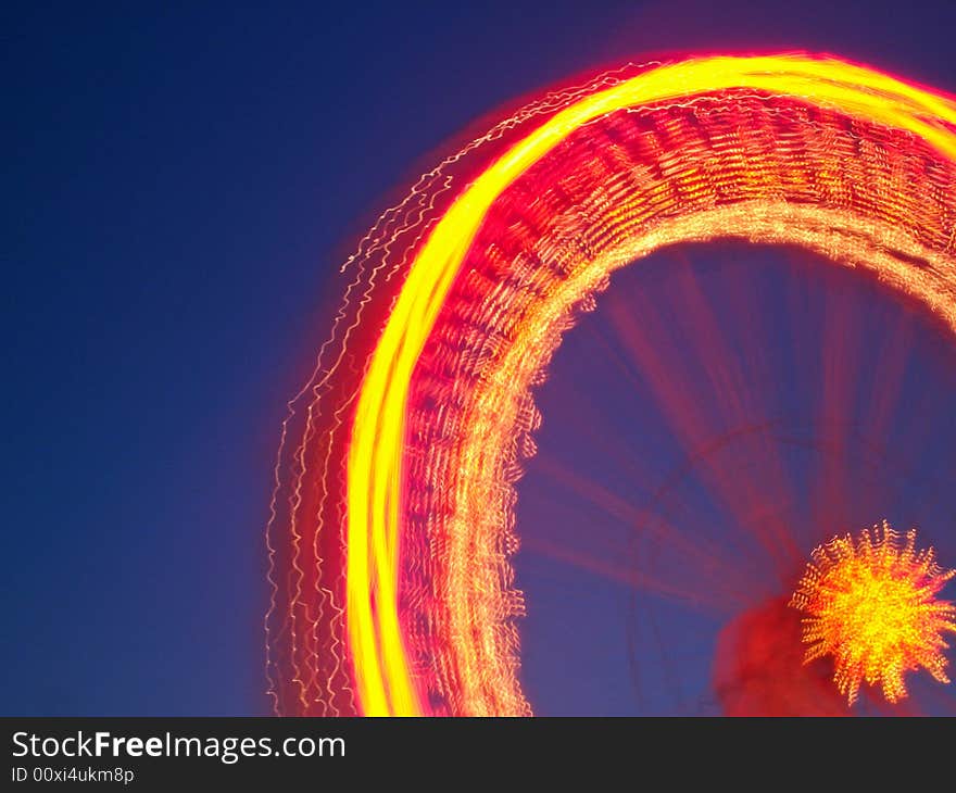 Image of a spinning wheel in an amusement park, long exposure