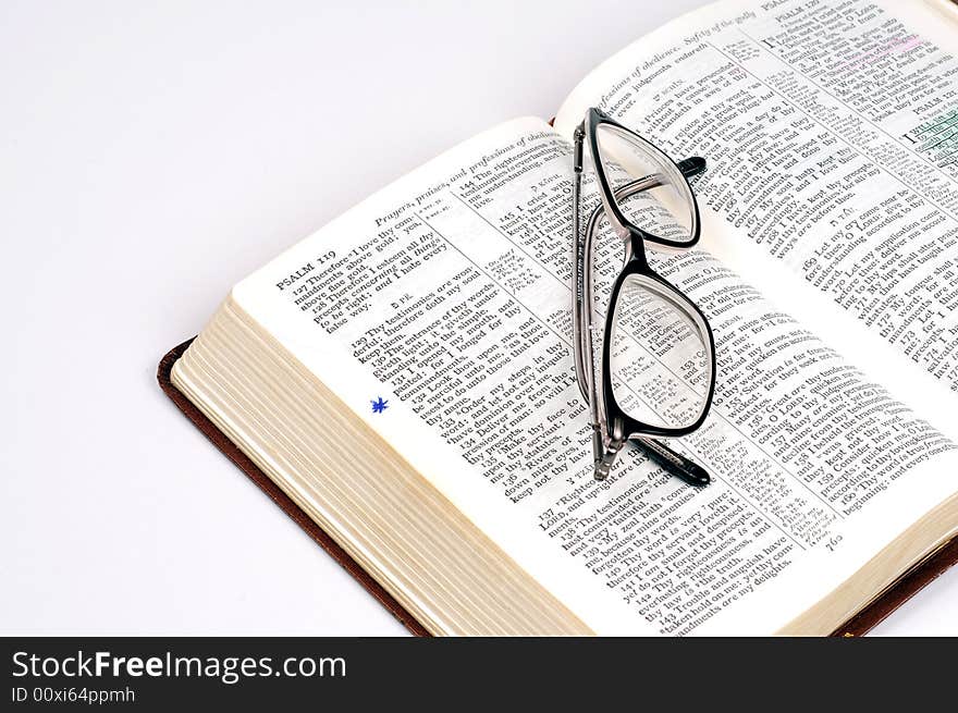 A bible with a pair of glasses. A bible with a pair of glasses