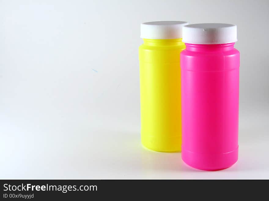 Two colorful bottles on white.