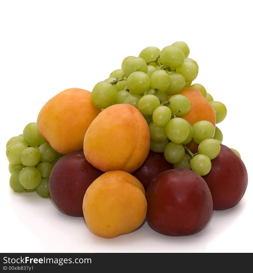 Grapes, apricots and plums isolated over white. Grapes, apricots and plums isolated over white