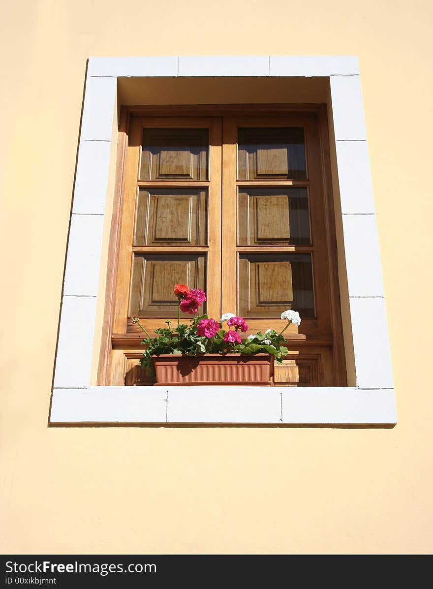 Sunlit geraniums on window ledge. Sunlit geraniums on window ledge