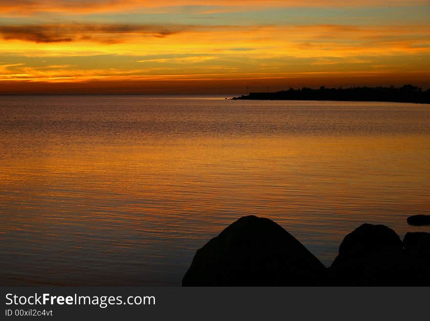 Silent sunset on balic sea with yellow clouds like a ribbons. Silent sunset on balic sea with yellow clouds like a ribbons