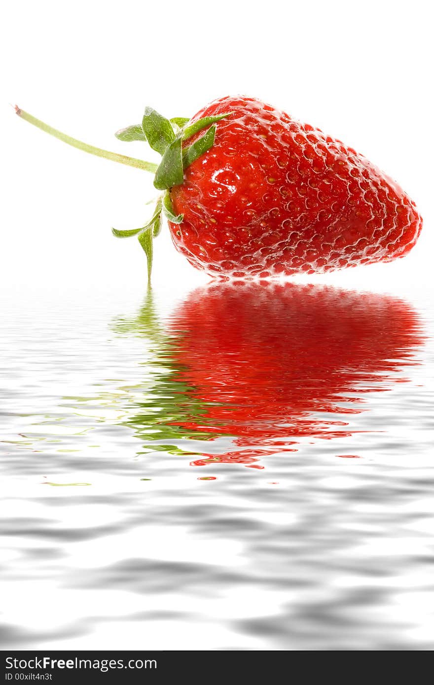 Delicious strawberry on white background with reflection in water