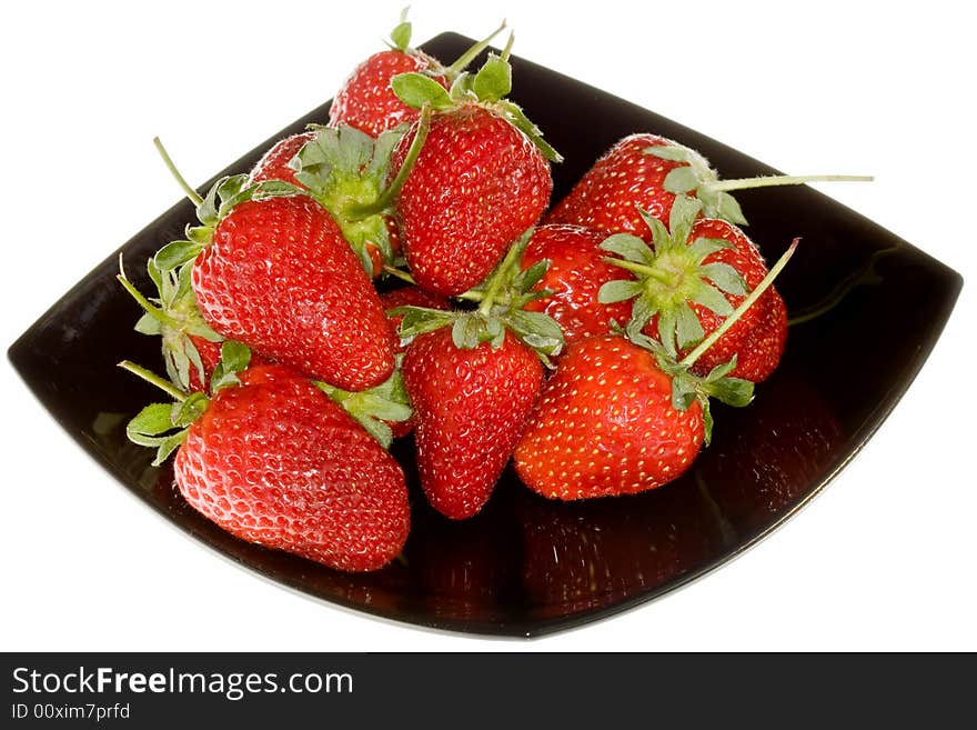 Delicious strawberries on black plate