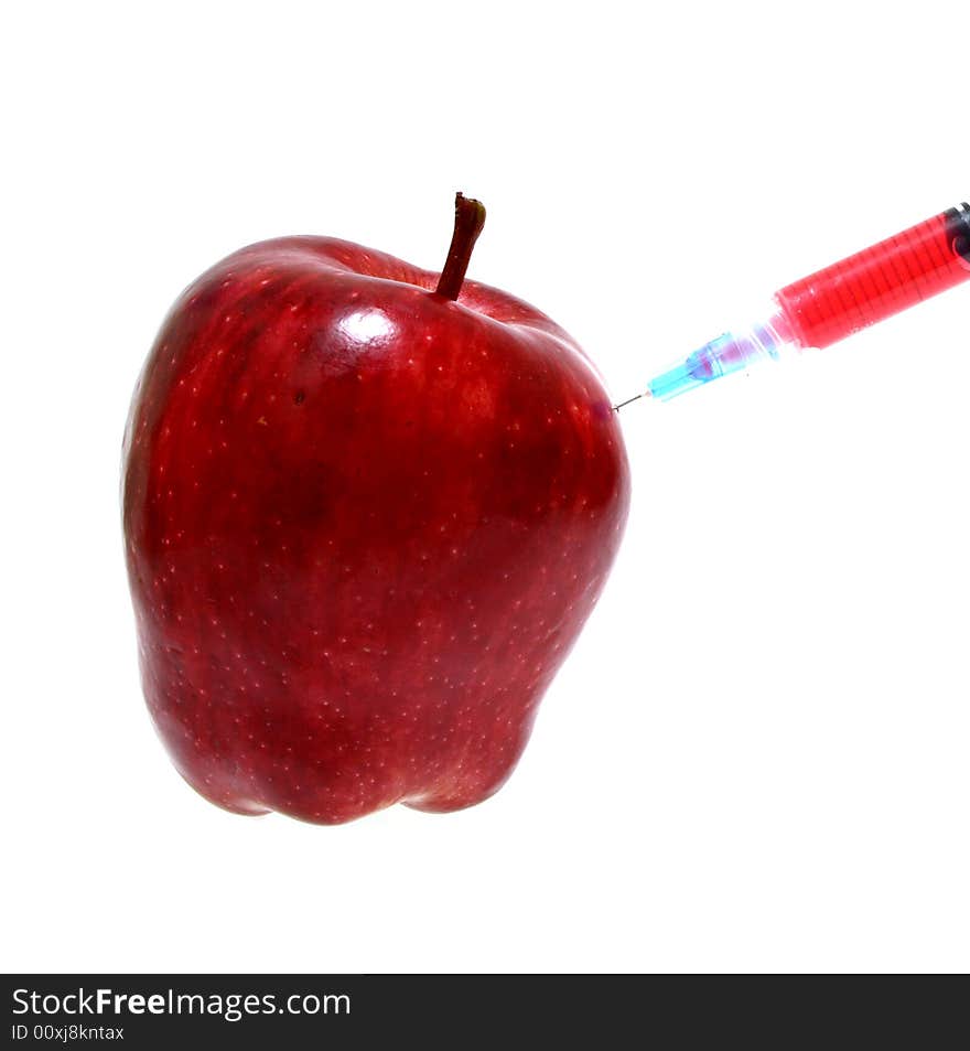 Syringe on a fresh and juicy red apple