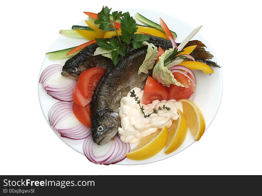 Salad from a Fried trout with vegetables and a lemon