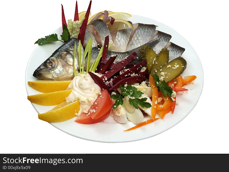 Salad from a salty herring with vegetables and a lemon