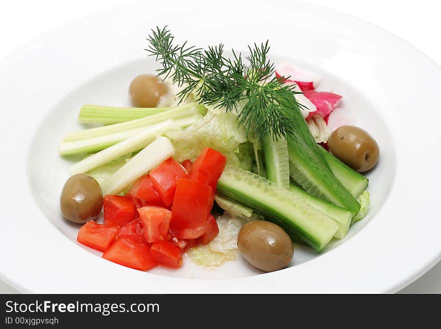 Vegetables on a plate isolated over white. Vegetables on a plate isolated over white.