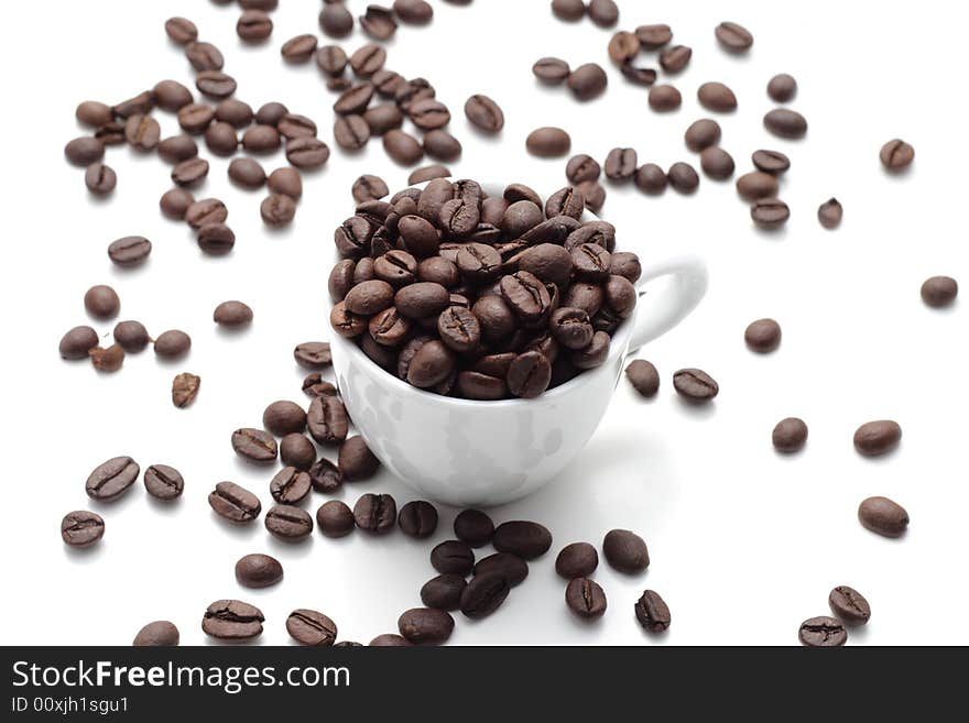 Coffee seed in a cup isolated on a white background