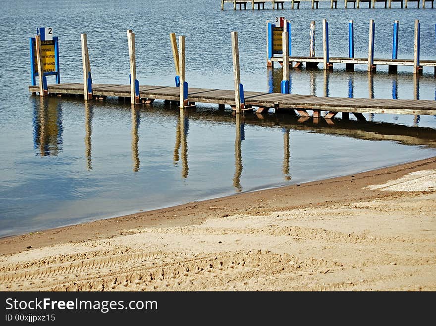 Pair of vacant boat ramps extending in the water.