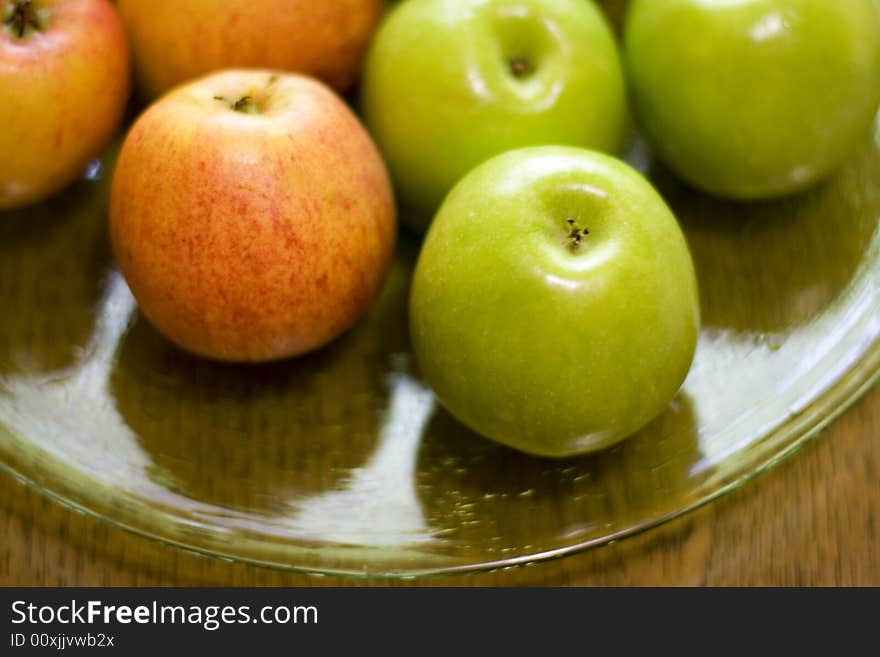 Red and green apples on a plate