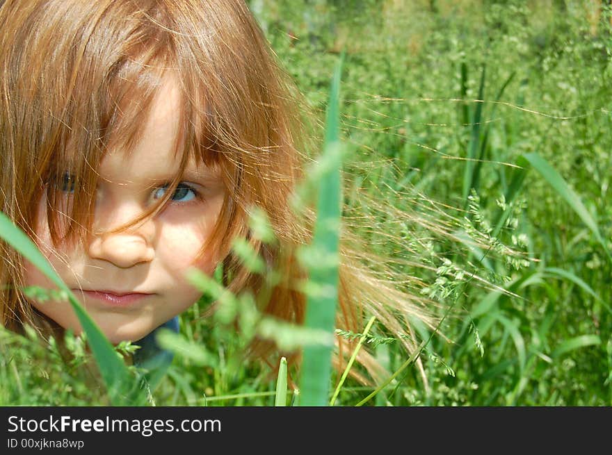 Portrait of a little sitting in grass little girl. Portrait of a little sitting in grass little girl