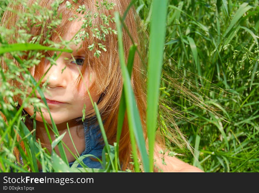 Portrait of a little sitting in grass little girl. Portrait of a little sitting in grass little girl