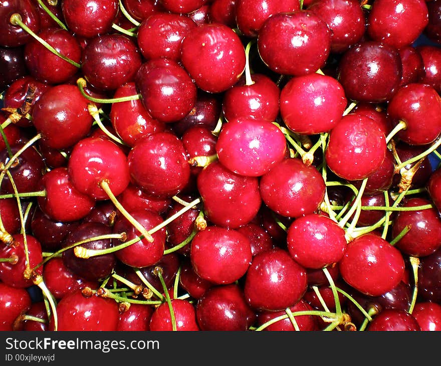 Juicy red cherries in a plate